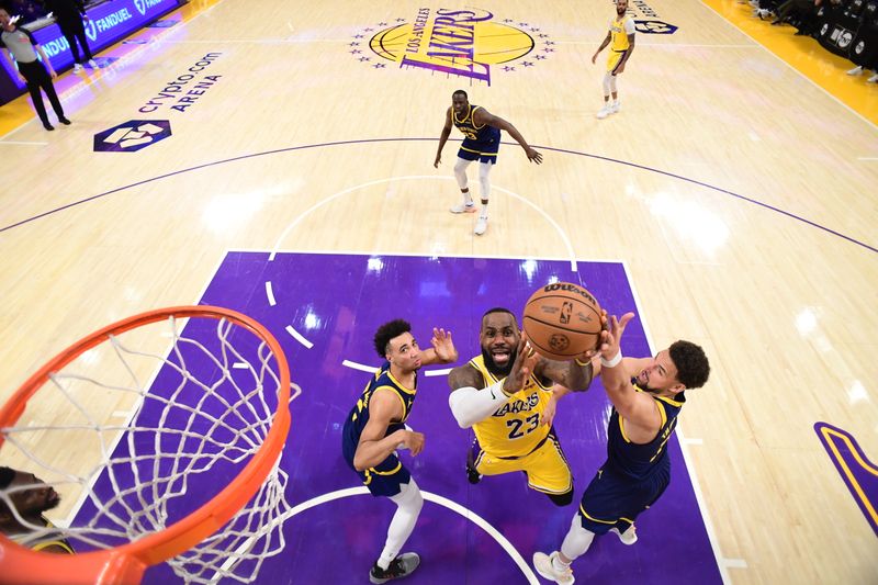 LOS ANGELES, CA - APRIL 9: LeBron James #23 of the Los Angeles Lakers drives to the basket during the game against the Golden State Warriors on April 9, 2024 at Crypto.Com Arena in Los Angeles, California. NOTE TO USER: User expressly acknowledges and agrees that, by downloading and/or using this Photograph, user is consenting to the terms and conditions of the Getty Images License Agreement. Mandatory Copyright Notice: Copyright 2024 NBAE (Photo by Adam Pantozzi/NBAE via Getty Images)