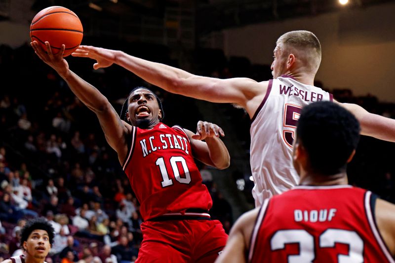 Jan 15, 2025; Blacksburg, Virginia, USA; North Carolina State Wolfpack guard Marcus Hill (10) shoots the ball against Virginia Tech Hokies center Patrick Wessler (5) during the second half at Cassell Coliseum. Mandatory Credit: Peter Casey-Imagn Images