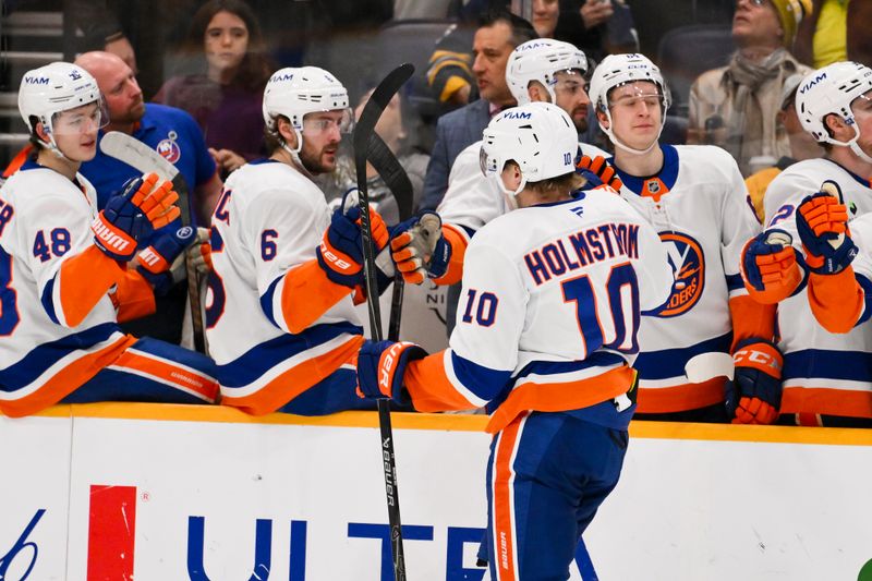Jan 8, 2026; Nashville, Tennessee, USA; New York Islanders right wing Simon Holmstrom (10) celebrates with his teammates after scoring a goal against the Nashville Predators during the second period at Bridgestone Arena. Mandatory Credit: Steve Roberts-Imagn Images
