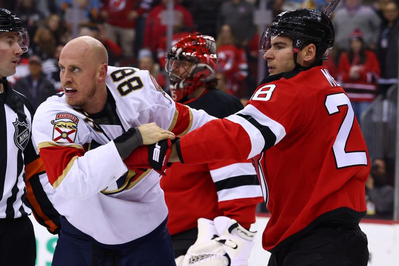 Jan 14, 2025; Newark, New Jersey, USA; Florida Panthers defenseman Nate Schmidt (88) and New Jersey Devils right wing Timo Meier (28) wrestle during the third period at Prudential Center. Mandatory Credit: Ed Mulholland-Imagn Images