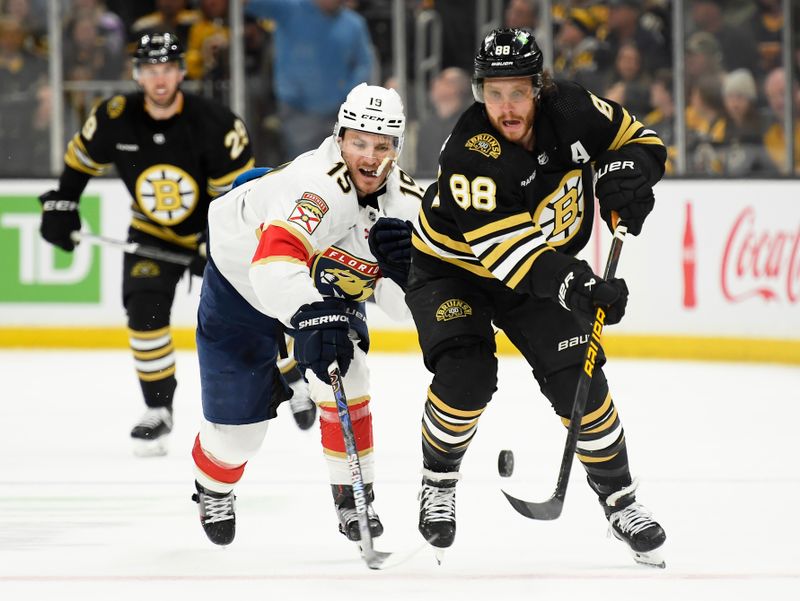 Apr 6, 2024; Boston, Massachusetts, USA; Boston Bruins right wing David Pastrnak (88) chips the puck past Florida Panthers left wing Matthew Tkachuk (19) during the third period at TD Garden. Mandatory Credit: Bob DeChiara-USA TODAY Sports