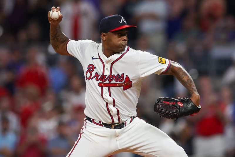 Sep 24, 2024; Atlanta, Georgia, USA; Atlanta Braves relief pitcher Raisel Iglesias (26) throws against the New York Mets in the ninth inning at Truist Park. Mandatory Credit: Brett Davis-Imagn Images
