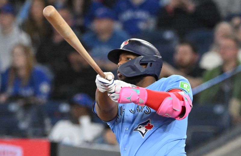 May 1, 2025; Toronto, Ontario, CAN;  Toronto Blue Jays first baseman Vladimir Guerrero Jr. (27) hits a three run home run against the Boston Red Sox in the eighth inning at Rogers Centre. Mandatory Credit: Dan Hamilton-Imagn Images