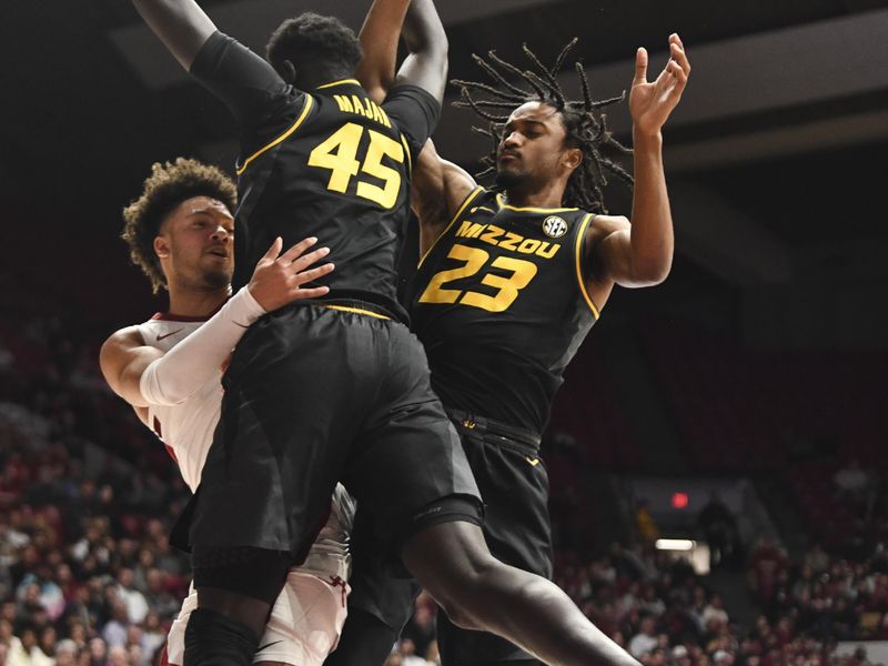 Jan 16, 2024; Tuscaloosa, Alabama, USA; Alabama guard Mark Sears (1) makes a pass around Missouri center Mabor Majak (45) and Missouri forward Aidan Shaw (23) in the game at Coleman Coliseum. Mandatory Credit: Gary Cosby Jr.-USA TODAY Sports