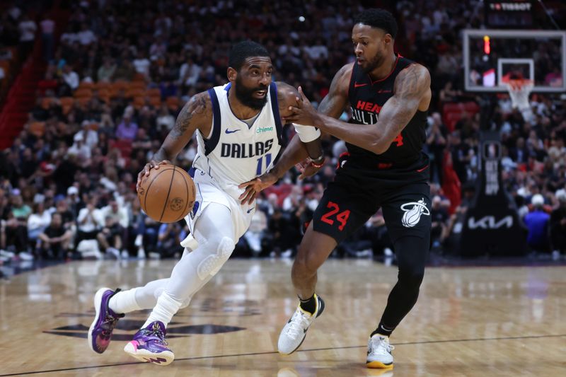 MIAMI, FLORIDA - APRIL 10: Kyrie Irving #11 of the Dallas Mavericks drives against Haywood Highsmith #24 of the Miami Heat during the second quarter of the game at Kaseya Center on April 10, 2024 in Miami, Florida. NOTE TO USER: User expressly acknowledges and agrees that, by downloading and or using this photograph, User is consenting to the terms and conditions of the Getty Images License Agreement. (Photo by Megan Briggs/Getty Images)