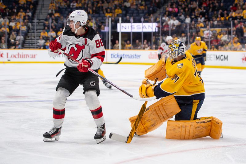 Feb 13, 2024; Nashville, Tennessee, USA;  Nashville Predators goaltender Juuse Saros (74) pokes the puck away from New Jersey Devils defenseman Kevin Bahl (88) during the second period at Bridgestone Arena. Mandatory Credit: Steve Roberts-USA TODAY Sports