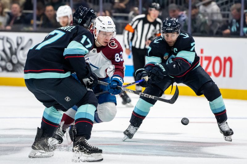 Oct 22, 2024; Seattle, Washington, USA;  Colorado Avalanche forward Ivan Ivan (82) battles  forward Jaden Schwartz (17) and forward Jordan Eberle (7) for the puck during the first period at Climate Pledge Arena. Mandatory Credit: Stephen Brashear-Imagn Images