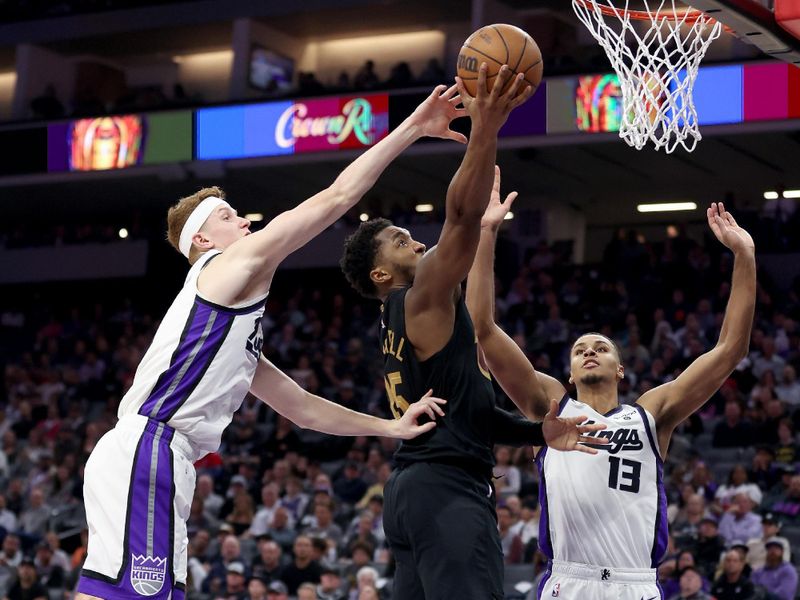 SACRAMENTO, CALIFORNIA - NOVEMBER 13:  Donovan Mitchell #45 of the Cleveland Cavaliers goes up for a shot against Kevin Huerter #9 and Keegan Murray #13 of the Sacramento Kings in the second half at Golden 1 Center on November 13, 2023 in Sacramento, California. NOTE TO USER: User expressly acknowledges and agrees that, by downloading and or using this photograph, User is consenting to the terms and conditions of the Getty Images License Agreement.  (Photo by Ezra Shaw/Getty Images)