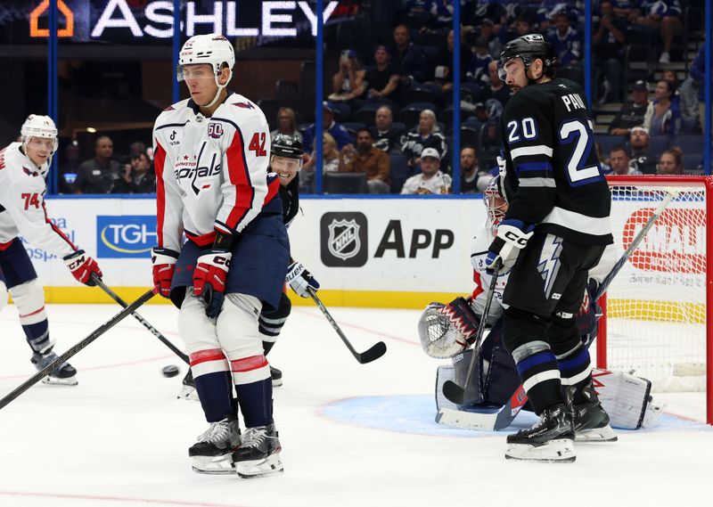 Oct 26, 2024; Tampa, Florida, USA; Washington Capitals defenseman Martin Fehervary (42) defends the puck against the Tampa Bay Lightning during the third period at Amalie Arena. Mandatory Credit: Kim Klement Neitzel-Imagn Images