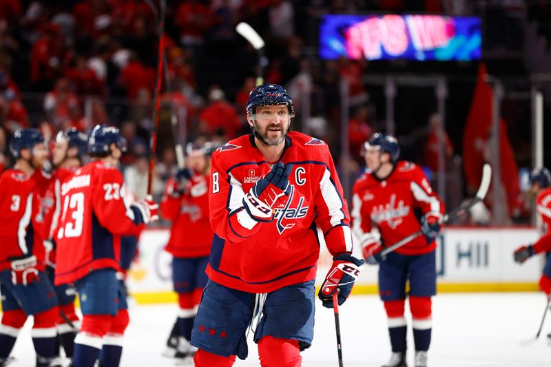 Mar 26, 2024; Washington, District of Columbia, USA; Washington Capitals left wing Alex Ovechkin (8) celebrates with his son on the bench after defeating the Detroit Red Wings in overtime at Capital One Arena. Mandatory Credit: Amber Searls-USA TODAY Sports