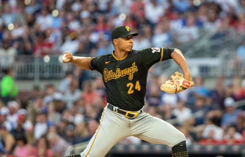 Sep 9, 2023; Cumberland, Georgia, USA; Pittsburgh Pirates starting pitcher Johan Oviedo (24) pitches against the Atlanta Braves in the first inning at Truist Park. Mandatory Credit: Jordan Godfree-USA TODAY Sports