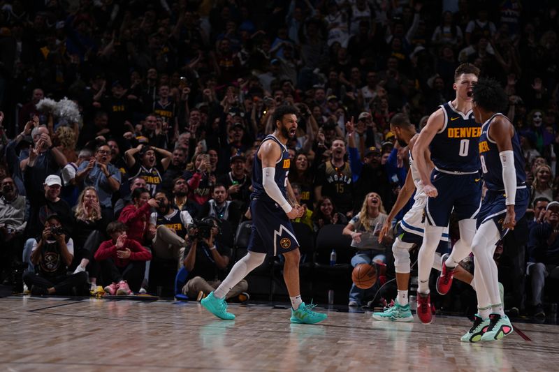 DENVER, CO - APRIL 10: Jamal Murray #27 of the Denver Nuggets celebrates s dunk by Christian Braun #0 during the game against the Minnesota Timberwolves on April 10, 2024 at the Ball Arena in Denver, Colorado. NOTE TO USER: User expressly acknowledges and agrees that, by downloading and/or using this Photograph, user is consenting to the terms and conditions of the Getty Images License Agreement. Mandatory Copyright Notice: Copyright 2024 NBAE (Photo by Bart Young/NBAE via Getty Images)