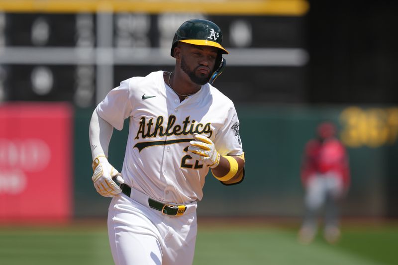 Jul 21, 2024; Oakland, California, USA; Oakland Athletics left fielder Miguel Andujar (22) rounds the bases after hitting a home run against the Los Angeles Angels during the fifth inning at Oakland-Alameda County Coliseum. Mandatory Credit: Darren Yamashita-USA TODAY Sports