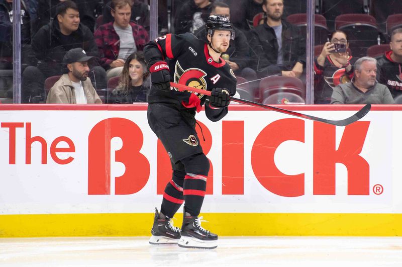 Oct 17, 2024; Ottawa, Ontario, CAN; Ottawa Senators defenseman Thomas Chabot (72) shoots the puck in the second period against the New Jersey Devils  at the Canadian Tire Centre. Mandatory Credit: Marc DesRosiers-Imagn Images