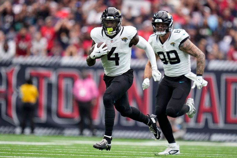 Jacksonville Jaguars running back Tank Bigsby (4) carries the ball up field during the second half of an NFL football game against the Houston Texans, Sunday, Sept. 29, 2024, in Houston. (AP Photo/Eric Christian Smith)