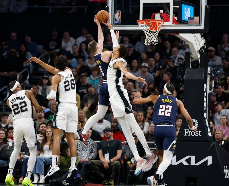 AUSTIN, TX - MARCH 15: Victor Wembanyama #1 of the San Antonio Spurs blocks the shot of Christian Braun #0 of the Denver Nuggets in the first half at Moody Center on March 15, 2024 in Austin, Texas. NOTE TO USER: User expressly acknowledges and agrees that, by downloading and or using this photograph, User is consenting to terms and conditions of the Getty Images License Agreement. (Photo by Ronald Cortes/Getty Images)