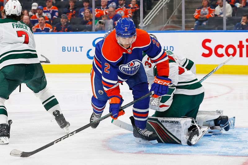 Feb 23, 2024; Edmonton, Alberta, CAN; Edmonton Oilers defensemen Evan Bouchard (2) crashes into Minnesota Wild goaltender Filip Gustavsson (32) during the third period at Rogers Place. Mandatory Credit: Perry Nelson-USA TODAY Sports