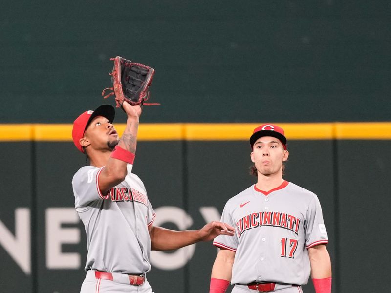 Apr 28, 2024; Arlington, Texas, USA; Cincinnati Reds left fielder Spencer Steer (7) catches the fly-out hit by Texas Rangers second baseman Marcus Semien (not shown) in front of center fielder Will Benson (30) during the first inning at Globe Life Field. Mandatory Credit: Jim Cowsert-USA TODAY Sports