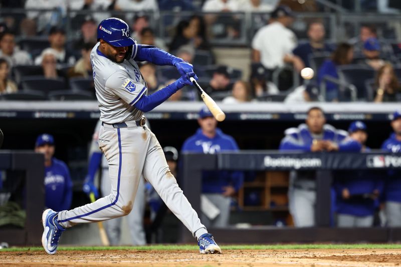 Oct 7, 2024; Bronx, New York, USA; Kansas City Royals third base Maikel Garcia (11) hits a RBI single against the New York Yankees in the fourth inning during game two of the ALDS for the 2024 MLB Playoffs at Yankee Stadium. Mandatory Credit: Vincent Carchietta-Imagn Images