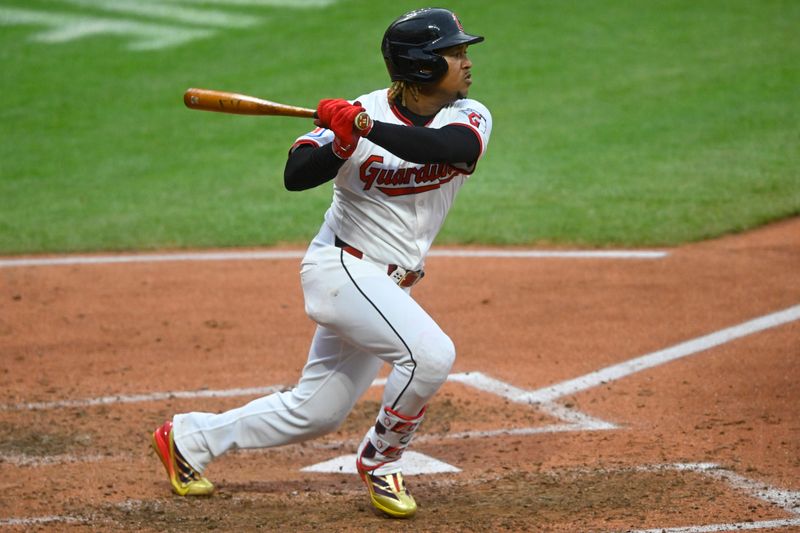 Apr 30, 2025; Cleveland, Ohio, USA; Cleveland Guardians third baseman Jose Ramirez (11) singles in the seventh inning against the Minnesota Twins at Progressive Field. Mandatory Credit: David Richard-Imagn Images