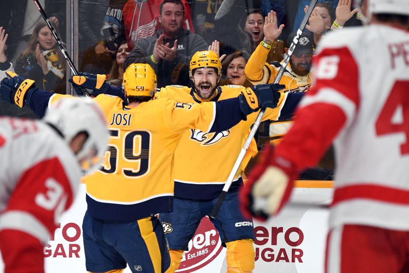 Mar 23, 2024; Nashville, Tennessee, USA; Nashville Predators left wing Filip Forsberg (9) celebrates with defenseman Roman Josi (59) after scoring the game-winning goal during the third period against the Detroit Red Wings at Bridgestone Arena. Mandatory Credit: Christopher Hanewinckel-USA TODAY Sports