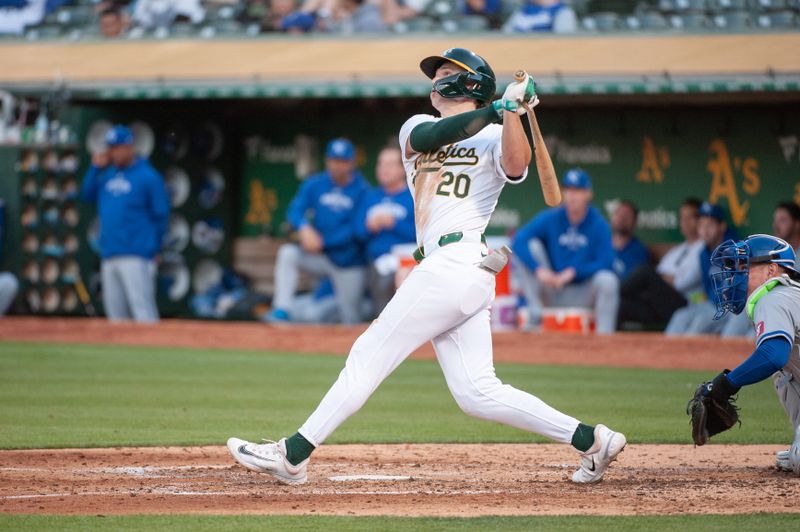 Jun 18, 2024; Oakland, California, USA; Oakland Athletics second base Zack Gelof (20) hits a home run against the Kansas City Royals during the fourth inning at Oakland-Alameda County Coliseum. Mandatory Credit: Ed Szczepanski-USA TODAY Sports