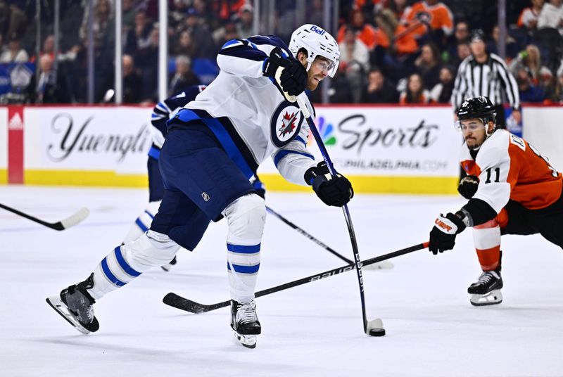 Feb 8, 2024; Philadelphia, Pennsylvania, USA; Winnipeg Jets center Adam Lowry (17) shoots against Philadelphia Flyers right wing Travis Konecny (11) in the second period at Wells Fargo Center. Mandatory Credit: Kyle Ross-USA TODAY Sports