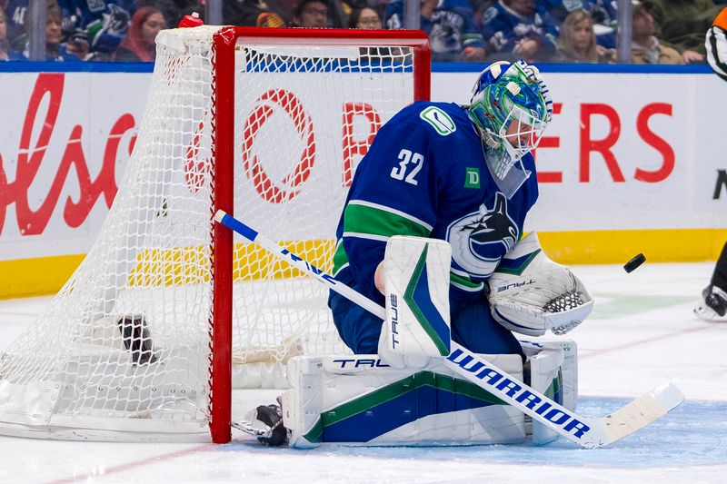 Nov 14, 2024; Vancouver, British Columbia, CAN; Vancouver Canucks goalie Kevin Lankinen (32) makes a save against the New York Islanders during the second period at Rogers Arena. Mandatory Credit: Bob Frid-Imagn Images
