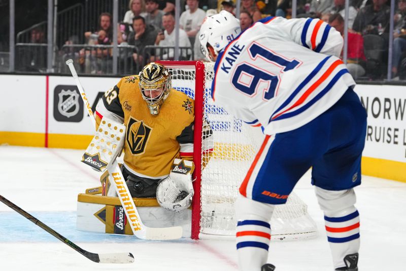 May 14, 2025; Las Vegas, Nevada, USA; Vegas Golden Knights goaltender Adin Hill (33) makes a save against Edmonton Oilers left wing Evander Kane (91) during the first period of game five of the second round of the 2025 Stanley Cup Playoffs at T-Mobile Arena. Mandatory Credit: Stephen R. Sylvanie-Imagn Images