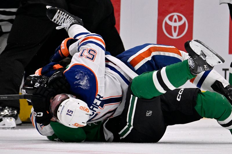 May 21, 2025; Dallas, Texas, USA; Dallas Stars center Oskar Bäck (10) and Edmonton Oilers defenseman Troy Stecher (51) fight in the third period during game one of the Western Conference Final of the 2025 Stanley Cup Playoffs at American Airlines Center. Mandatory Credit: Jerome Miron-Imagn Images