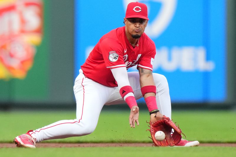 May 4, 2024; Cincinnati, Ohio, USA; Cincinnati Reds second base Santiago Espinal (4) fields a ground ball in the second inning of a baseball game against the Baltimore Orioles at Great American Ball Park. Mandatory Credit: The Cincinnati Enquirer-USA TODAY Sports