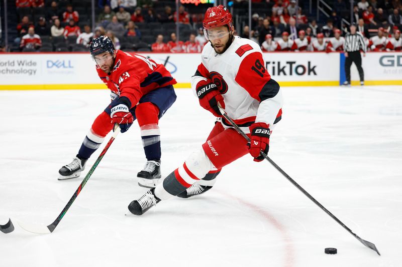 Dec 11, 2025; Washington, District of Columbia, USA; Carolina Hurricanes defenseman K'Andre Miller (19) skates with the puck as Washington Capitals right wing Tom Wilson (43) defends during the second period at Capital One Arena. Mandatory Credit: Geoff Burke-Imagn Images
