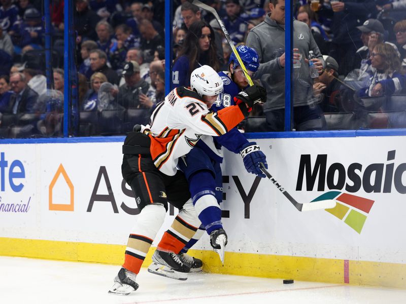 Jan 13, 2024; Tampa, Florida, USA;  Anaheim Ducks center Isac Lundestrom (21) and Tampa Bay Lightning defenseman Nick Perbix (48) battle for the puck in the second period at Amalie Arena. Mandatory Credit: Nathan Ray Seebeck-USA TODAY Sports