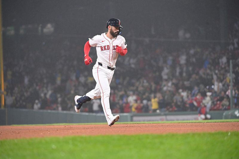 Apr 11, 20024; Boston, Massachusetts, USA; Boston Red Sox catcher Connor Wong (12) hits a home run against the Baltimore Orioles during the eighth inning at Fenway Park. Mandatory Credit: Eric Canha-USA TODAY Sports