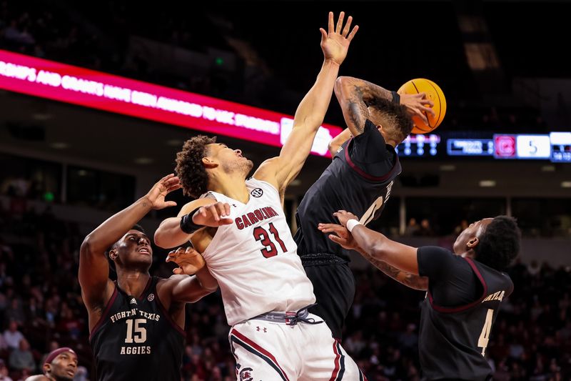 Jan 14, 2023; Columbia, South Carolina, USA; Texas A&M Aggies forward Henry Coleman III (15) guard Dexter Dennis (0) guard Wade Taylor IV (4) battle for a rebound with South Carolina Gamecocks forward Benjamin Bosmans-Verdonk (31) the first half at Colonial Life Arena. Mandatory Credit: Jeff Blake-USA TODAY Sports