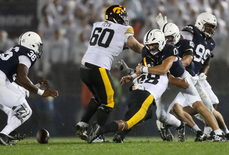 Sep 23, 2023; University Park, Pennsylvania, USA; Penn State Nittany Lions linebacker Dominic DeLuca (0) causes Iowa Hawkeyes running back Kamari Moulton (28) to fumble the ball during the fourth quarter at Beaver Stadium. Penn State defeated Iowa 31-0. Mandatory Credit: Matthew O'Haren-USA TODAY Sports