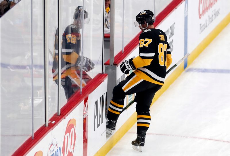 Feb 18, 2024; Pittsburgh, Pennsylvania, USA;  Pittsburgh Penguins center Sidney Crosby (87) enters the penalty box after committing a hooking penalty against the Los Angeles Kings during the second period at PPG Paints Arena. Mandatory Credit: Charles LeClaire-USA TODAY Sports