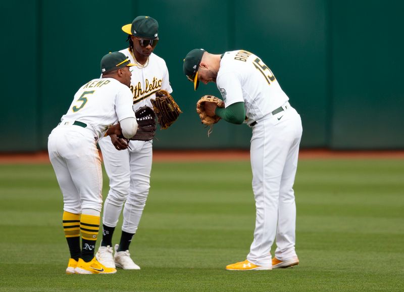 Sep 2, 2023; Oakland, California, USA; Oakland Athletics outfielders Tony Kemp (5), Esteury Ruiz (1) and Seth Brown (15) celebrate their 2-1 victory over the Los Angeles Angels at Oakland-Alameda County Coliseum. Mandatory Credit: D. Ross Cameron-USA TODAY Sports