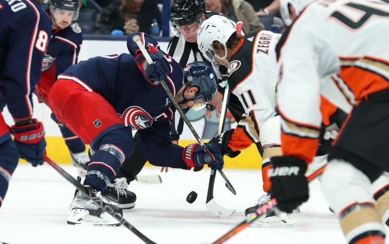 Oct 24, 2023; Columbus, Ohio, USA; Columbus Blue Jackets center Boone Jenner (38) and Anaheim Ducks center Trevor Zegras (11) face off during the second period at Nationwide Arena. Mandatory Credit: Joseph Maiorana-USA TODAY Sports