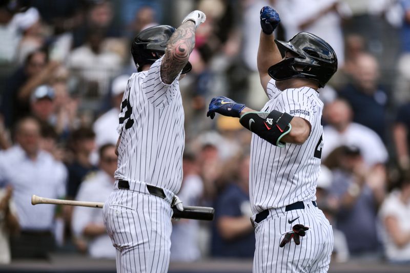 Aug 22, 2024; Bronx, New York, USA; New York Yankees designated hitter Giancarlo Stanton (27) is greeted at home plate by New York Yankees outfielder Alex Verdugo (24) after hitting a three run home run against the Cleveland Guardians during the fifth inning at Yankee Stadium. Mandatory Credit: John Jones-USA TODAY Sports