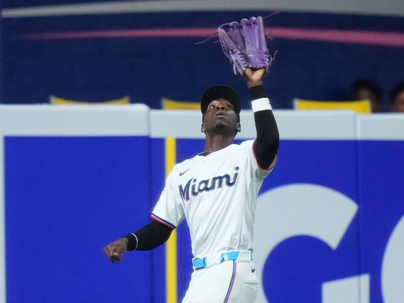 May 22, 2024; Miami, Florida, USA; Miami Marlins outfielder Nick Gordon (1) catches a fly ball against the Milwaukee Brewers during the third inning at loanDepot Park. Mandatory Credit: Rich Storry-USA TODAY Sports