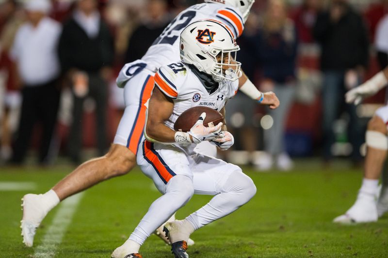 Nov 11, 2023; Fayetteville, Arkansas, USA;  Auburn Tigers running back Brian Battie (21) runs the ball during the fourth quarter against the Arkansas Razorbacks at Donald W. Reynolds Razorback Stadium. Auburn won 48-10. Mandatory Credit: Brett Rojo-USA TODAY Sports