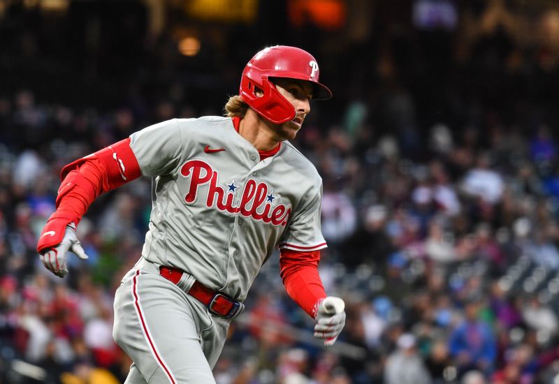 May 13, 2023; Denver, Colorado, USA; Philadelphia Phillies second baseman Bryson Stott (5) hits a double in the fourth inning against the Colorado Rockies at Coors Field. Mandatory Credit: John Leyba-USA TODAY Sports