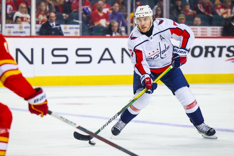 Mar 18, 2024; Calgary, Alberta, CAN; Washington Capitals right wing T.J. Oshie (77) controls the puck against the Calgary Flames during the third period at Scotiabank Saddledome. Mandatory Credit: Sergei Belski-USA TODAY Sports