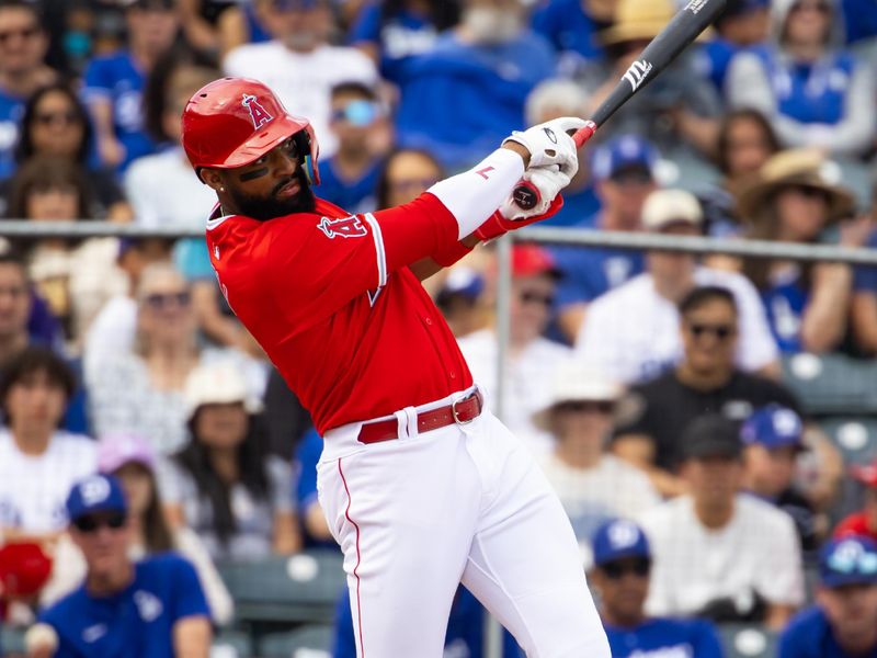 Feb 24, 2024; Tempe, Arizona, USA; Los Angeles Angels outfielder Jo Adell hits an RBI triple against the Los Angeles Dodgers during a spring training game at Tempe Diablo Stadium. Mandatory Credit: Mark J. Rebilas-USA TODAY Sports
