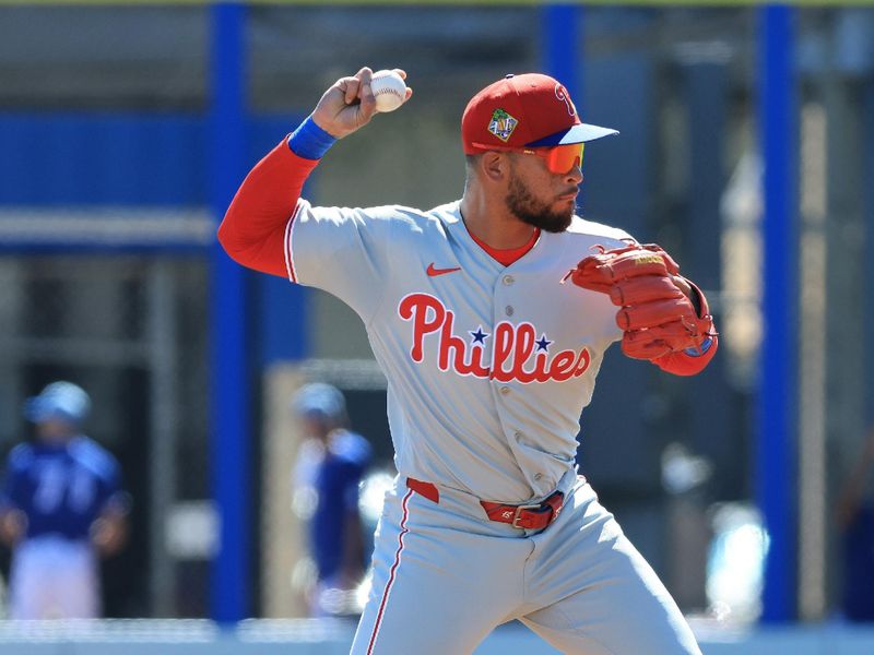 Feb 21, 2026; Dunedin, Florida, USA;  Philadelphia Phillies infielder Edmundo Sosa (33) throws the ball to first base for an out against the Toronto Blue Jays during the first inning at TD Ballpark. Mandatory Credit: Kim Klement Neitzel-Imagn Images