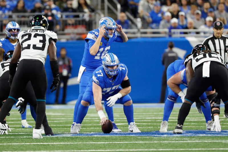 Detroit Lions quarterback Jared Goff (16) gets set to run a play behind center Frank Ragnow (77) Against the Jacksonville Jaguars in the first half of an NFL football game in Detroit, Sunday, Nov. 17, 2024. (AP Photo/Rick Osentoski)