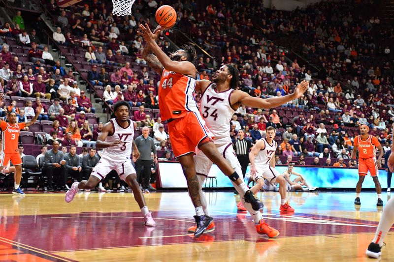 Mar 1, 2025; Blacksburg, Virginia, USA; Syracuse Orange center Eddie Lampkin Jr. (44) makes a move toward the basket as Virginia Tech Hokies forward Mylyjael Poteat (34) defends during the first half at Cassell Coliseum. Mandatory Credit: Brian Bishop-Imagn Images