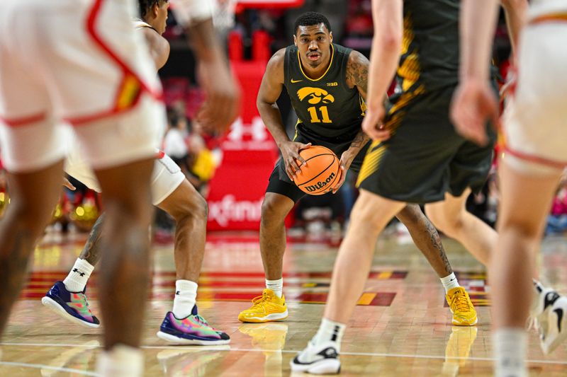 Feb 14, 2024; College Park, Maryland, USA;  Iowa Hawkeyes guard Tony Perkins (11) looks to pass during  the fist half against the Maryland Terrapins at Xfinity Center. Mandatory Credit: Tommy Gilligan-USA TODAY Sports