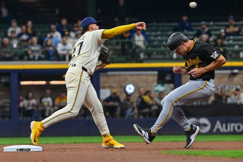 May 13, 2024; Milwaukee, Wisconsin, USA;  Milwaukee Brewers shortstop Willy Adames (27) attempts a double play after forcing out Pittsburgh Pirates right fielder Bryan Reynolds (10) in the first inning at American Family Field. Mandatory Credit: Benny Sieu-USA TODAY Sports